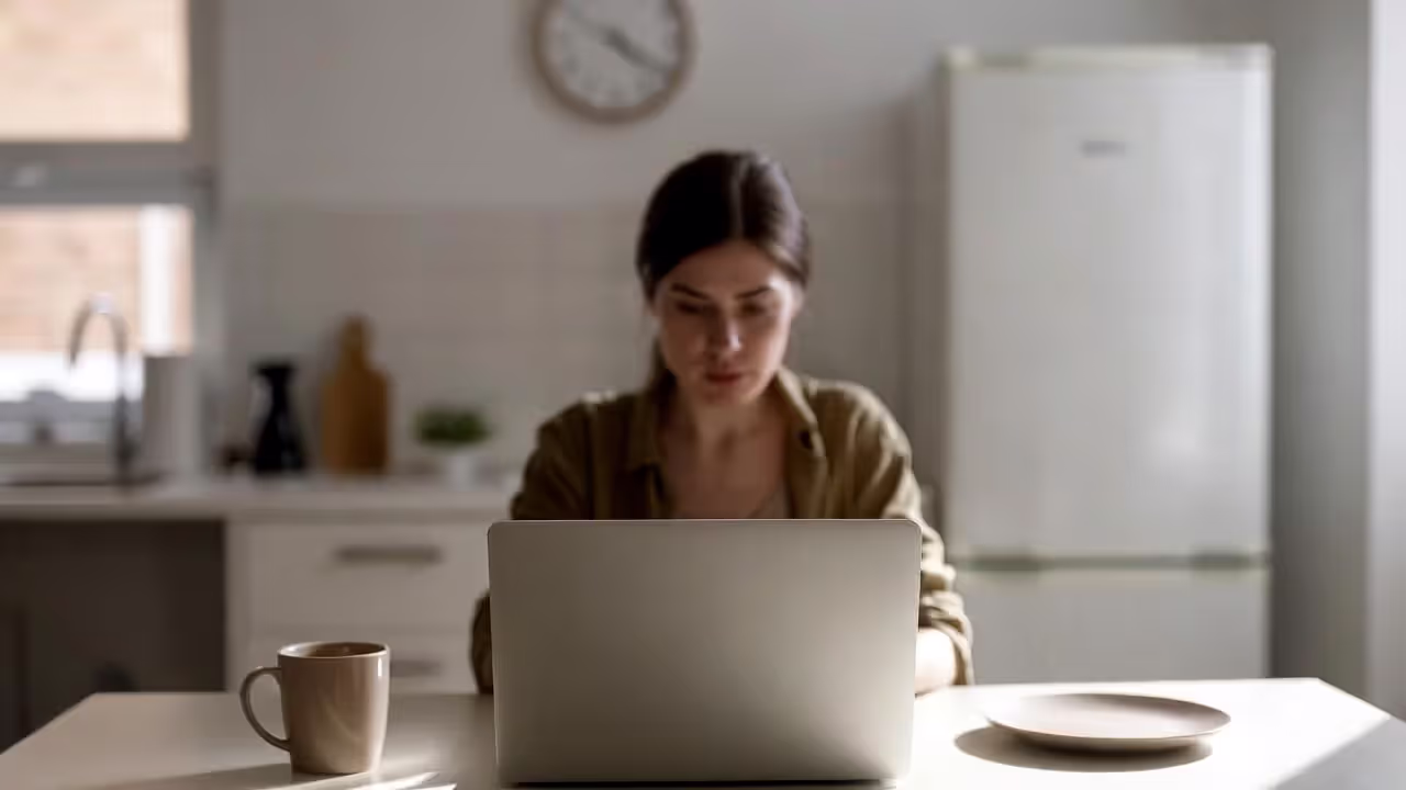 Person working from home in kitchen during lockdown with only coffee, representing rise of intermittent fasting