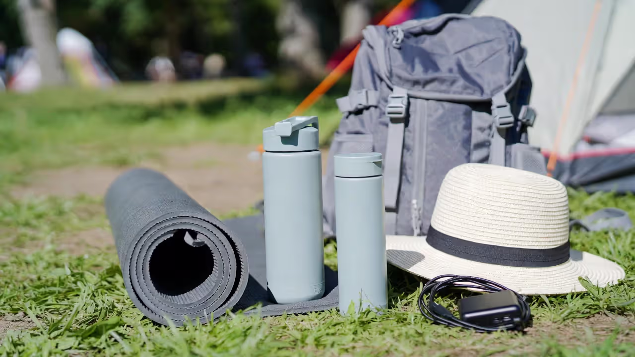 Essential items packed for an outdoor yoga festival.