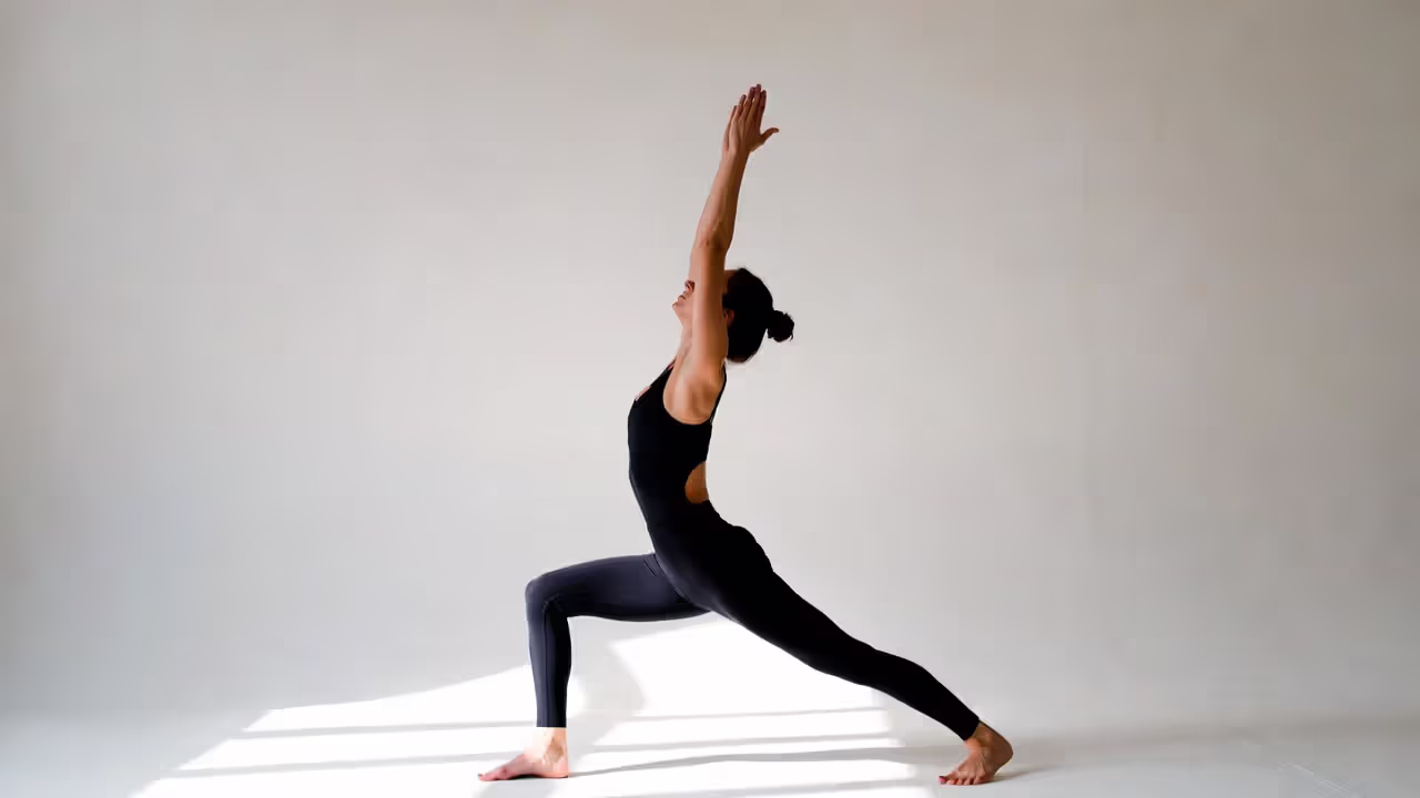 Person holding Warrior I pose with active leg engagement